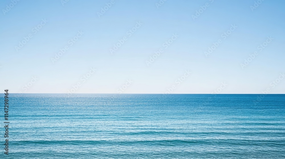 Naklejka premium Calm Blue Ocean Under Clear Sky with Gentle Waves and Tranquil Atmosphere