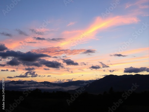 Vibrant sunset in a panoramic nature scene with mountains, picturesque, beautiful, countryside