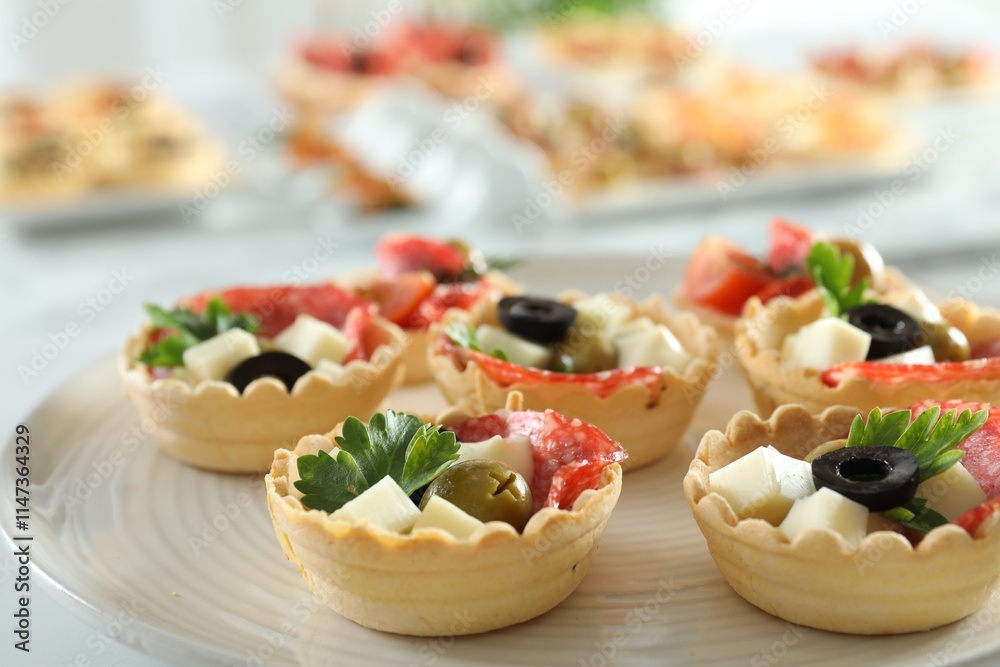 Many tasty canapes on white table, closeup Many tasty canapes on white table, closeup