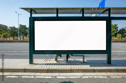 Fototapeta Naklejka Na Ścianę i Meble -  Background texture of a large outdoor billboard or advertisement display with a blank white mockup copy space at the back of a sheltered bus stop.	