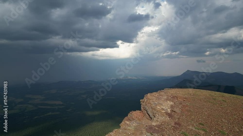 Dramatic storm clouds gathering over a vast mountain valley and forest. Alberta, Canada.