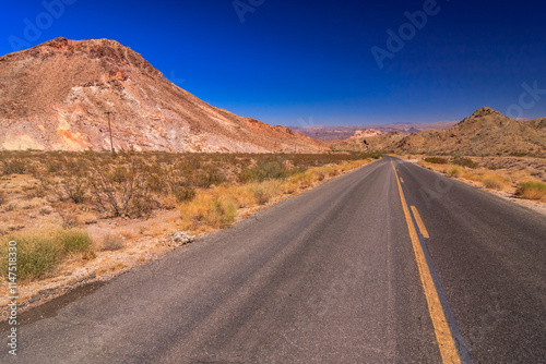 A long road with a yellow line down the middle