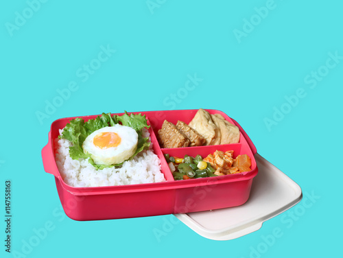 A balanced, healthy meal of rice, egg, stir-fried vegetables, and tofu-tempeh, in a lunchbox, suits busy students and office workers. A free lunch program by Prabowo in Indonesia served in a lunchbox. photo