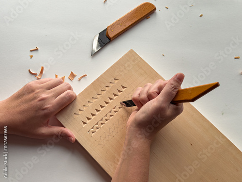 Close up of detailed wood carving process with tools photo