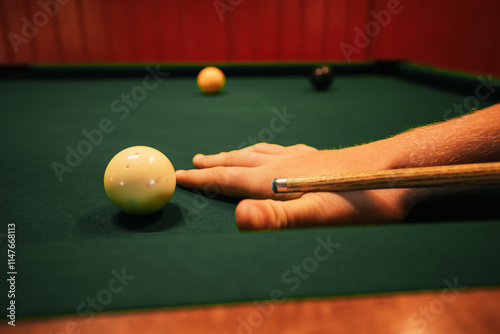 Close up of hands taking shot in pool game photo