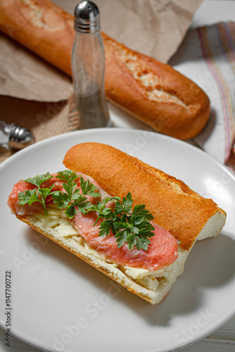 Sandwich with smoked red fish on a light table