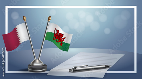 Qatar and Wales National flags on small table with bokeh background, cooperative relationship