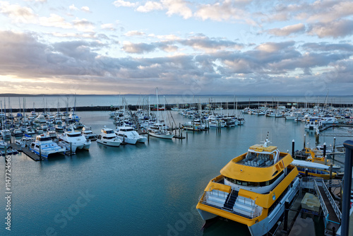 Dramatic clouds at dawn catching the light on the water Hervey Bay marina photo