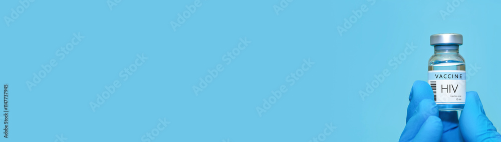 A doctor holds a vial of the HIV vaccine. Experimental HIV vaccine vial for immunization against HIV disease.Copy space.Banner A doctor holds a vial of the HIV vaccine. Experimental HIV vaccine vial for immunization against HIV disease.Copy space.Banner