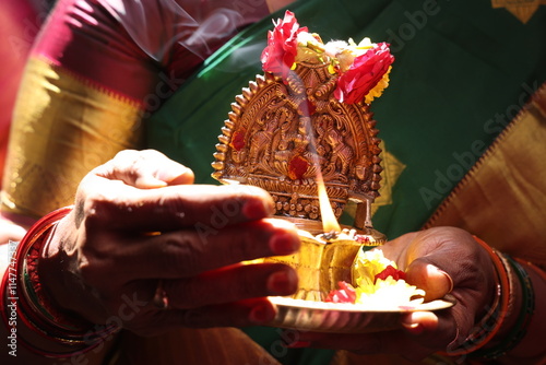 lighting of kuthu vilaku or kamatchi amman vilaku in south Indian tradition photo