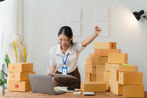 Online Business Success: A young woman celebrates a successful online business venture, surrounded by a mountain of shipping boxes,  exuding confidence and joy.  photo