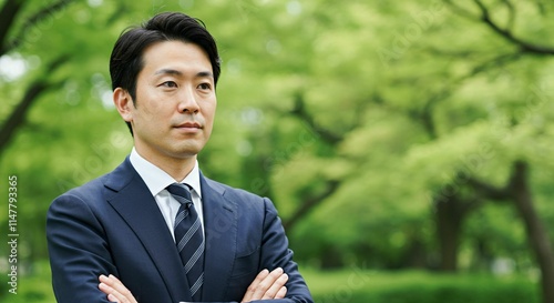 Japanese Professional in Formal Suit Amidst Greenery: A Representation of Ambition and Success
