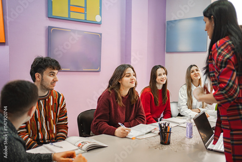 Female teacher explaining subject to her teenage students at language school