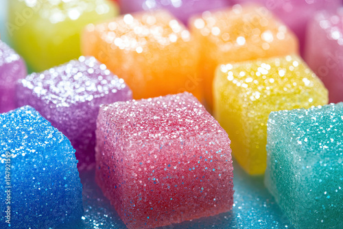 Macro shot of sugar cubes coated with colorful edible glitter for a festive look photo