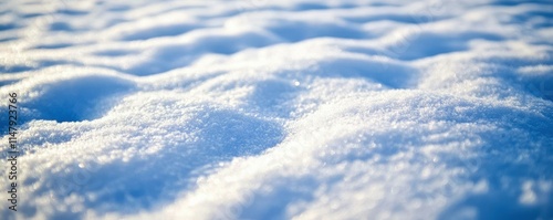 A close-up of the snow on the ground, with intricate patterns in shades of blue and white