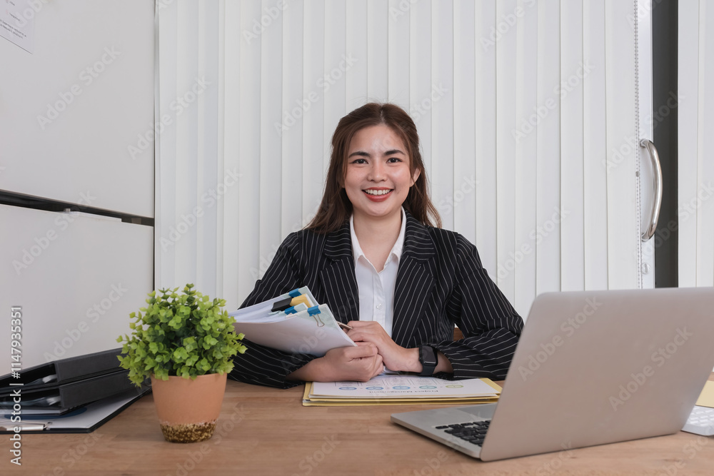 Cheerful business lady working on laptop in office, Asian happy beautiful businesswoman in formal suit work in workplace. Attractive female employee office worker smile. Cheerful business lady working on laptop in office, Asian happy beautiful businesswoman in formal suit work in workplace. Attractive female employee office worker smile.