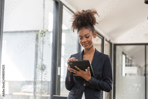 Free Download Confident Businesswoman Analyzing Work Plan on Digital Tablet in Modern Office Setting - GFXLoad