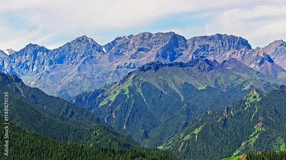 Aerial view of green forest with mountain natural landscape in summer. Beautiful natural scenery in Jiangbulake Scenic Area, Xinjiang, China. Aerial view of green forest with mountain natural landscape in summer. Beautiful natural scenery in Jiangbulake Scenic Area, Xinjiang, China.