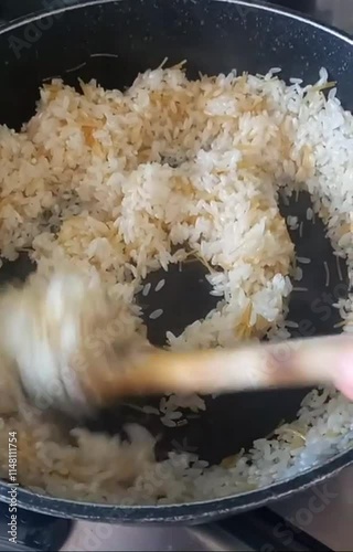 Cooking rice in kitchen