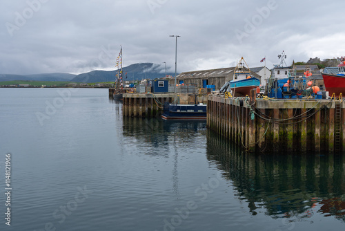 Colorful fishing boats docked at Stromness harbor, Orkney Islands photo