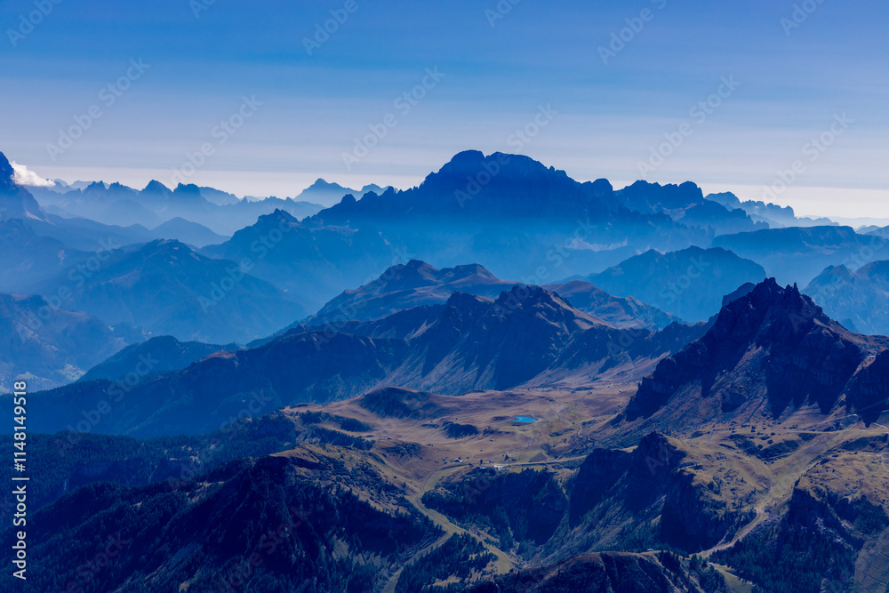 Aerial view of the mountain silhouettes on the horizon. Misty and foggy sky with Dolomites mountain range on the horizon. Blue mist in the mountains Aerial view of the mountain silhouettes on the horizon. Misty and foggy sky with Dolomites mountain range on the horizon. Blue mist in the mountains