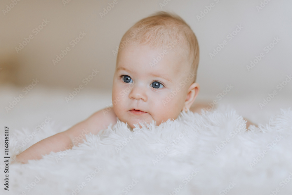 A baby is laying on a white blanket with its head tilted to the side. The baby's eyes are closed, and it is resting A baby is laying on a white blanket with its head tilted to the side. The baby's eyes are closed, and it is resting