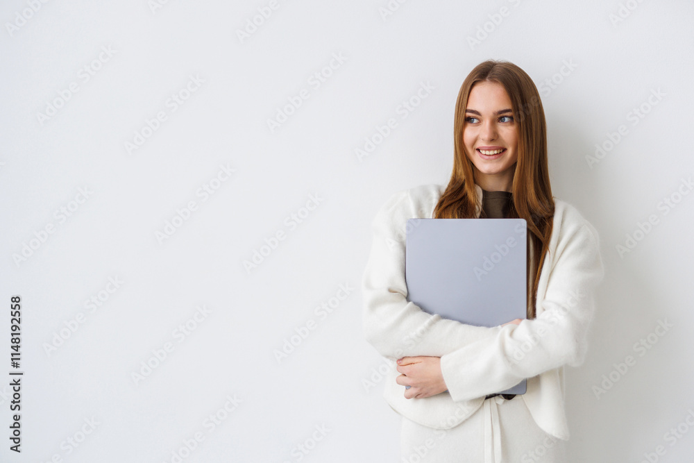 Portrait of a woman standing isolated over white background, holding laptop Portrait of a woman standing isolated over white background, holding laptop