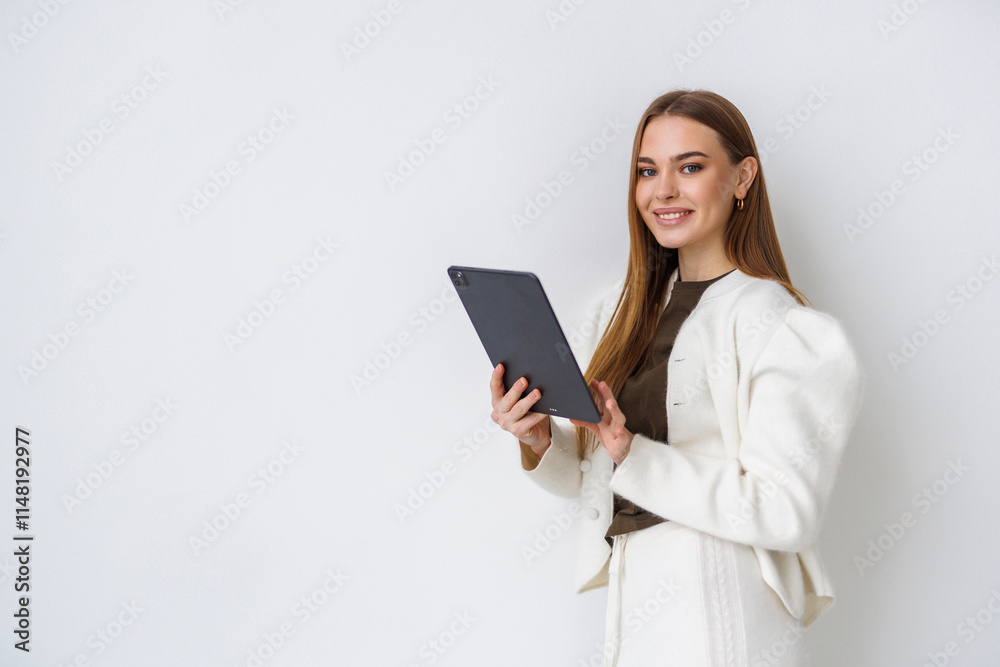 Young and beautiful business woman with the tablet computer isolated on white Young and beautiful business woman with the tablet computer isolated on white