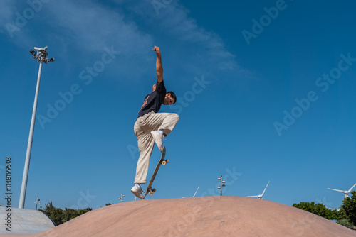 young skater wearing black tshirt jumps a ramp in a skate park. movement 1 photo