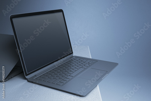 Modern open laptop with blank screen and metallic keyboard on textured surface in blue minimalistic background for design presentation. 3D Rendering photo