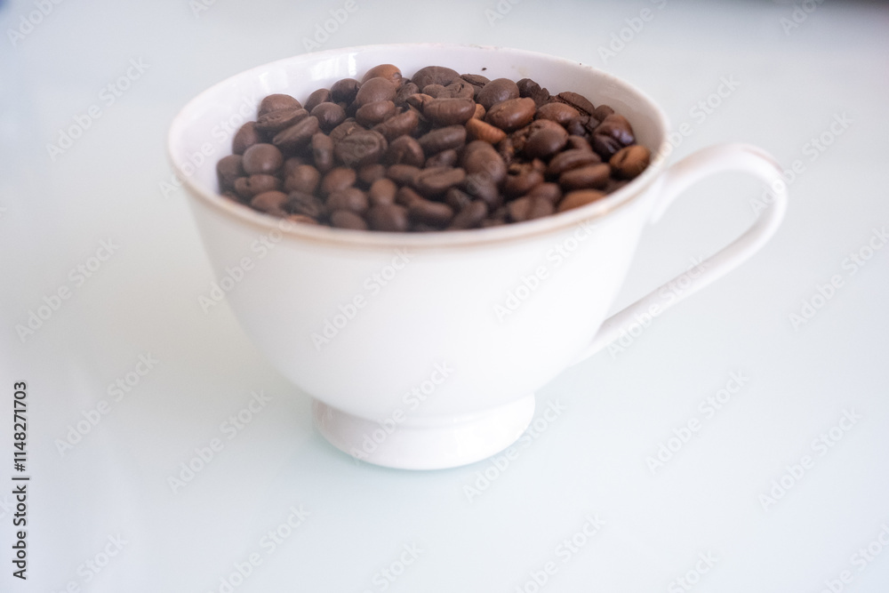 white antique cup of coffee with beans white antique cup of coffee with beans