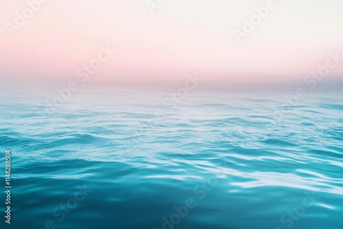 The ocean is calm and blue with a pink sky in the background. The water is still and peaceful, creating a serene atmosphere