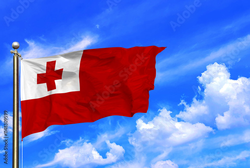 The Flag Of Tonga Flying Gracefully in the Clear Sky photo