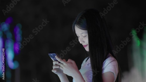 Woman using smartphone at night, Night lights, Bokeh of lights.