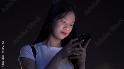 Woman using smartphone at night, Night lights, Bokeh of lights.