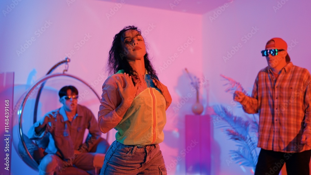 Attractive happy dancer looking at camera while smart woman moving at rhyme with neon light. Professional hispanic performer break dancing while wearing colorful cloth with diverse friend. Regalement. Attractive happy dancer looking at camera while smart woman moving at rhyme with neon light. Professional hispanic performer break dancing while wearing colorful cloth with diverse friend. Regalement.