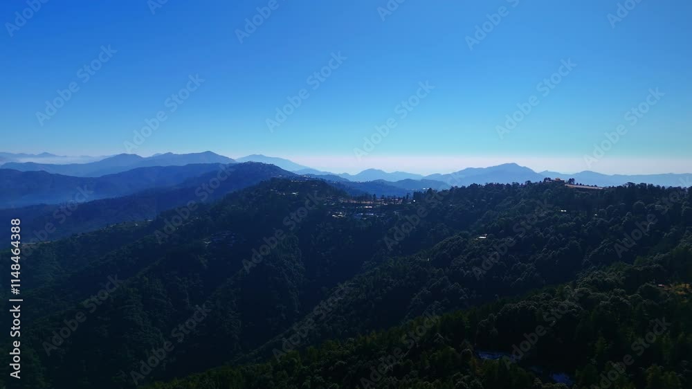 Aerial shot of a mountain landscape with overlapping ridges covered in shadows, creating a dramatic natural scenery during golden hours Aerial shot of a mountain landscape with overlapping ridges covered in shadows, creating a dramatic natural scenery during golden hours