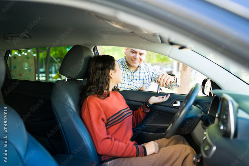 Proud father handing over car keys to his teenage daughter, symbolizing trust, responsibility, and a new chapter of independence as she learns to drive Proud father handing over car keys to his teenage daughter, symbolizing trust, responsibility, and a new chapter of independence as she learns to drive