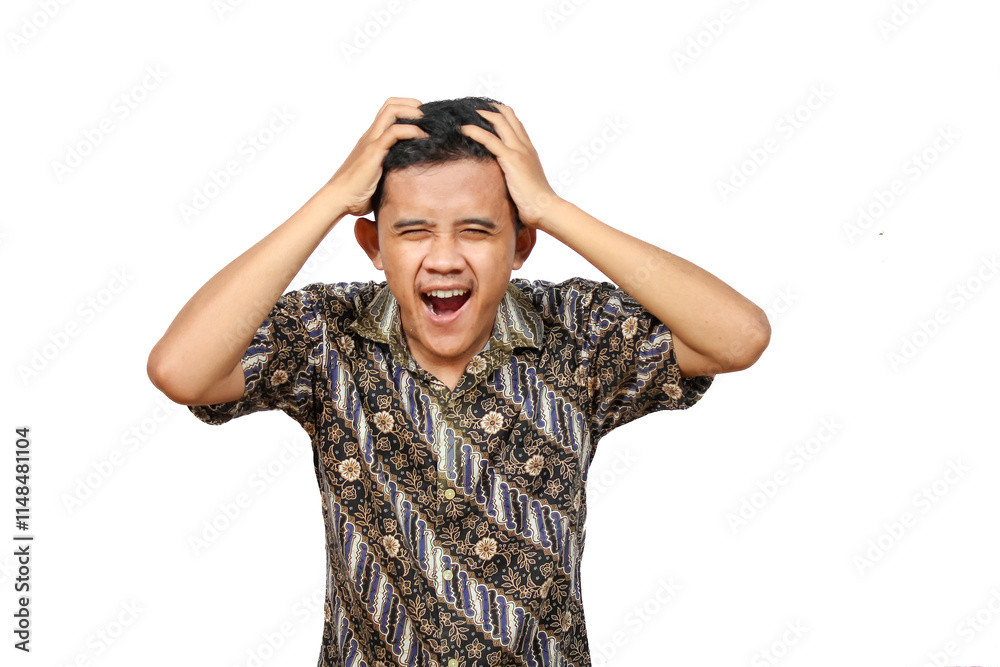 Asian man in batik clothes showing stress expression holding head with both hands isolated on white background Asian man in batik clothes showing stress expression holding head with both hands isolated on white background