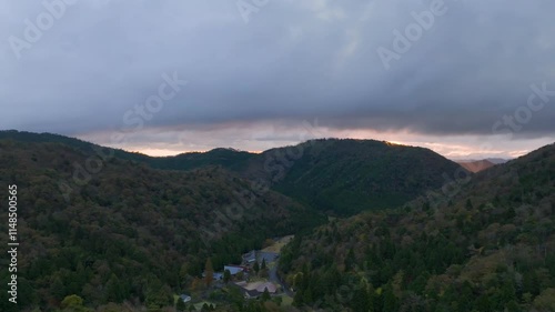 Taking off with morning sunrise glow over foggy mountain landscape