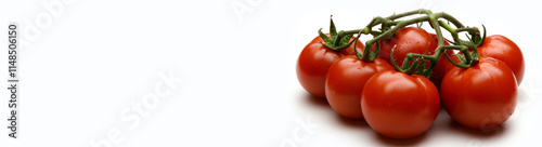 Cluster of ripe cherry tomatoes on the vine isolated on a white background. Copy space, wide aspect ratio.