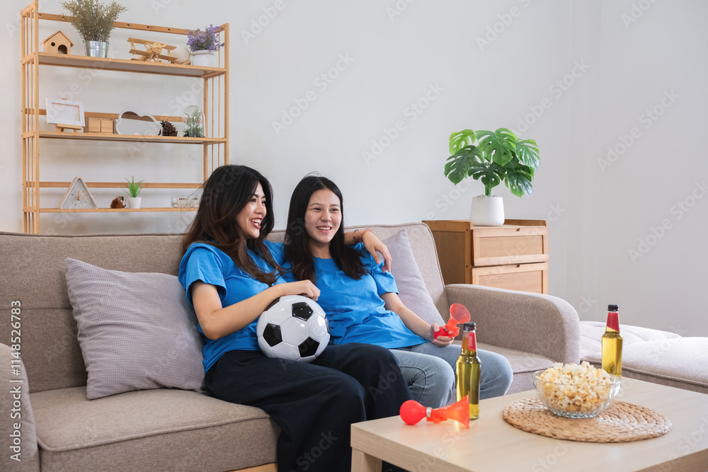 Lesbian Couple Cheering for Football Together on Cozy Sofa, Enjoying Snacks and Drinks, Celebrating Sports Enthusiasm in Modern Home Setting Lesbian Couple Cheering for Football Together on Cozy Sofa, Enjoying Snacks and Drinks, Celebrating Sports Enthusiasm in Modern Home Setting