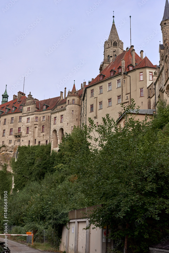 Fototapeta premium Majestic Sigmaringen Castle Perched on Rugged Cliff Above Tranquil Danube: Historic Hohenzollern Residence Showcases Medieval Architecture and Royal Collections in Picturesque Baden-Wurttemberg