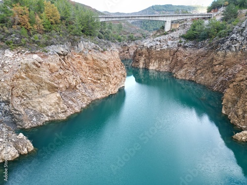 reservoir with emerald water rocky shore photo