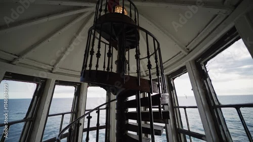 Spiral staircase inside a lighthouse overlooking the ocean