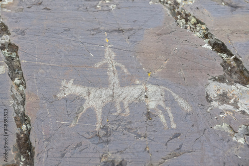 Bayan-Ulgii / Mongolia - August 2019: Ancient petroglyphs carved into rocks in northern Mongolia photo