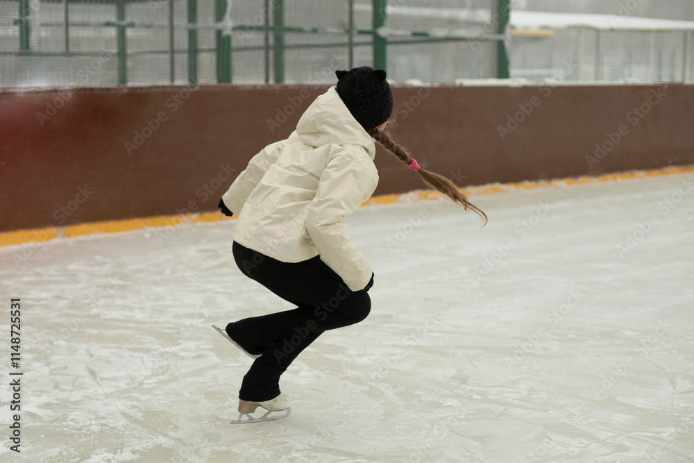 Obraz premium Girl on skates. Winter holidays. Ice skating. Sports details. Exercise on ice.