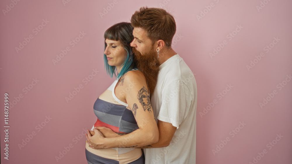Pregnant woman with blue hair and man with beard embracing over pink background showcasing love and togetherness Pregnant woman with blue hair and man with beard embracing over pink background showcasing love and togetherness