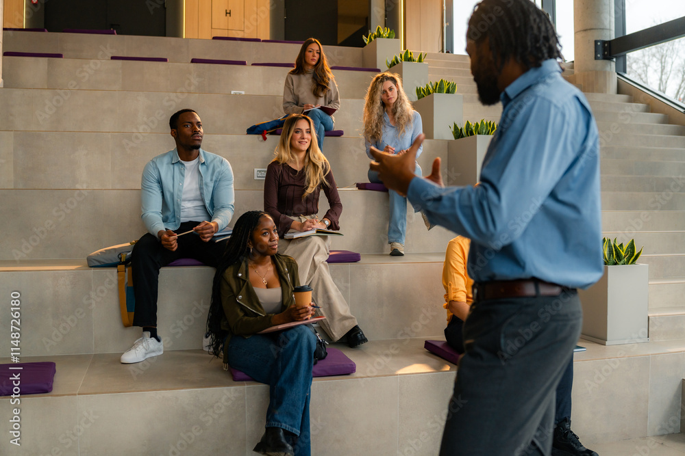 Fototapeta premium University professor giving lesson to multicultural students sitting on modern steps