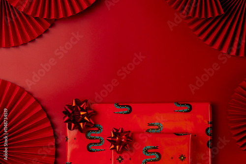 Chinese New Year theme with red paper fans and gift boxes. Year of the Snake. photo